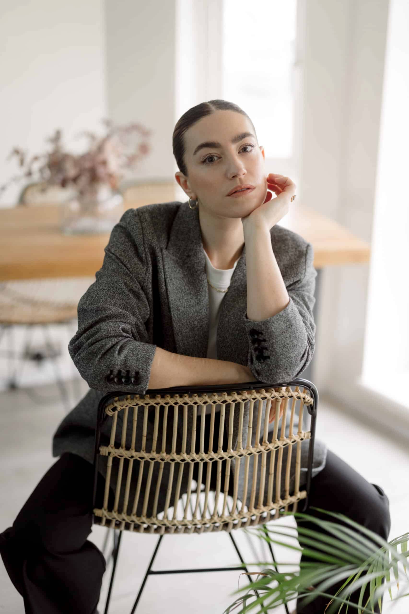 Lauren, the founder of Wedding Hair and Makeup by Lauren, sits confidently in a modern, light-filled space. With sleek, natural makeup and a polished low bun, she embodies effortless beauty and contemporary elegance. Dedicated to creating chic, fashion-forward bridal looks, Lauren brings a personal touch to every bride’s big day.