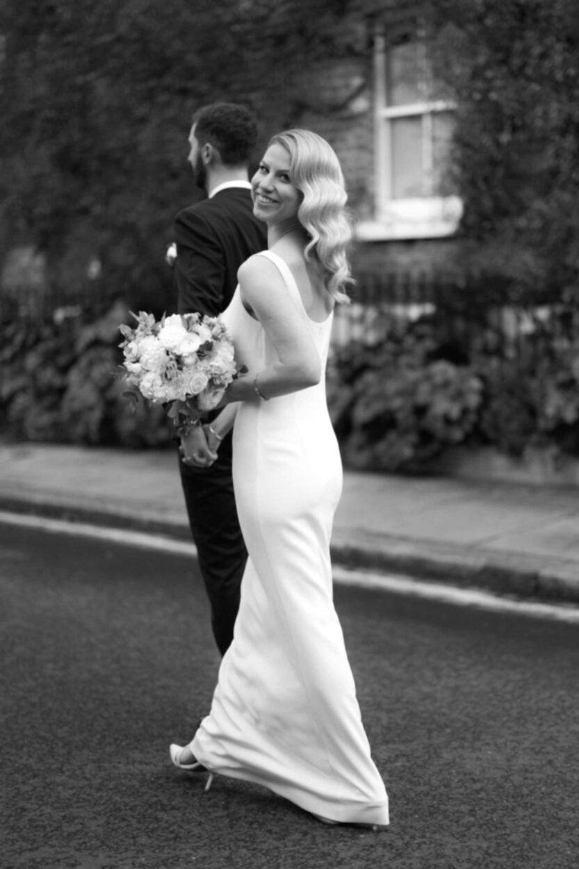 Elegant Bride With Classic Hollywood Waves And Radiant Natural Makeup, Wearing A Fitted Sleek White Column Dress With Scoop Neckline, Holding A Romantic White And Blush Bouquet, Captured In Timeless Black And White Photography
